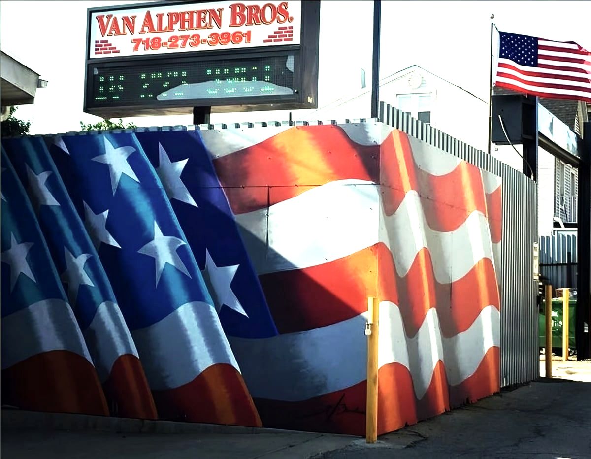 Van Alphen Bros. sign above a fence painted as an American flag
